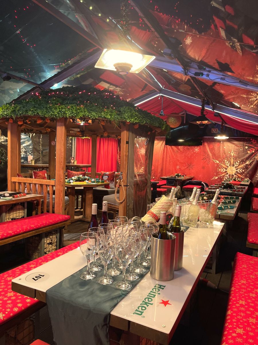 Festive party tables set with glasses in the marquee