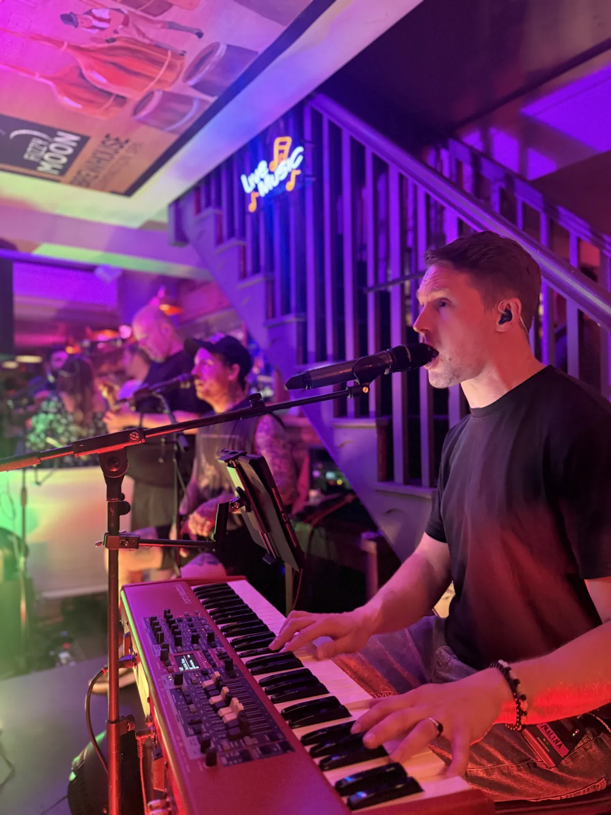 Live music at Fizzy Moon Brewhouse Leamington Spa — band performing under the Live Music neon